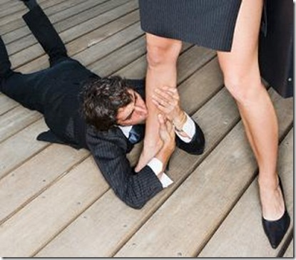 man on ground kissing woman's leg